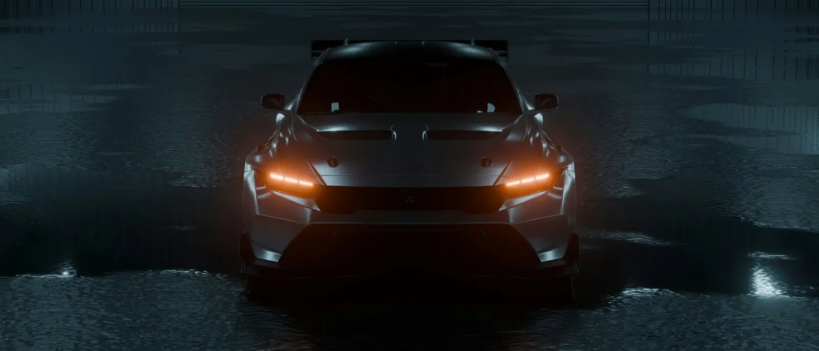 A dark grey sports car with amber headlights, seen head-on on a rain-wet floor in a dim hangar